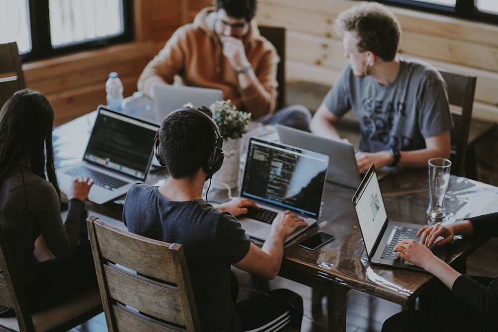 Creative team collaborating around a laptop in a meeting